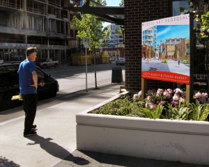 Passerby Views Public Art Proposal Billboard in Pinnacle Square